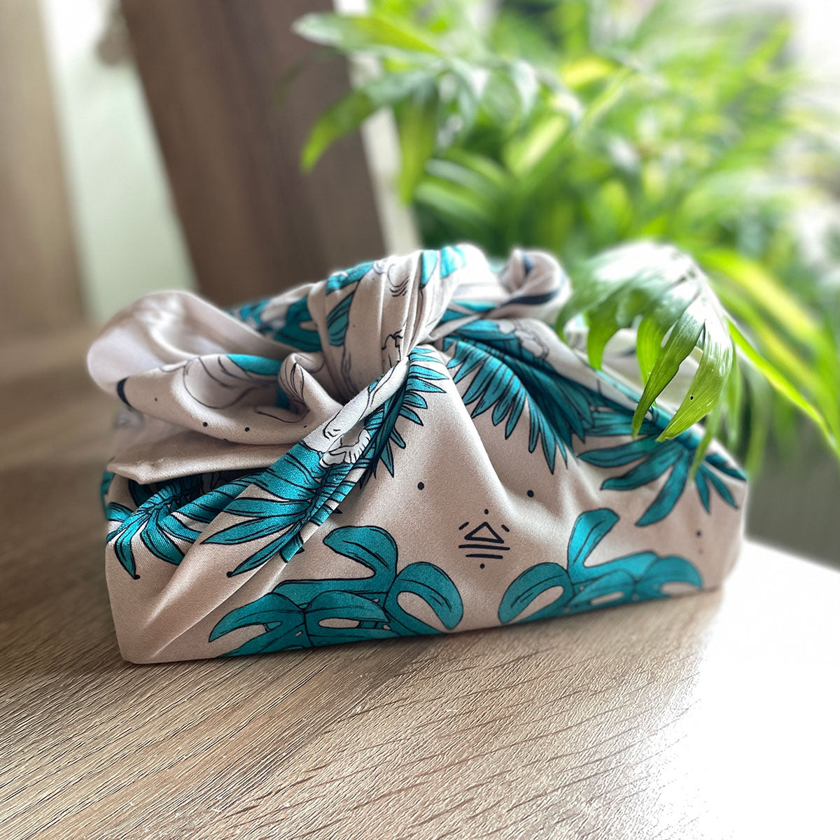 fabric gift wrap, gifting experience, textile wrapped around box, botanical illustrations in teal and cream