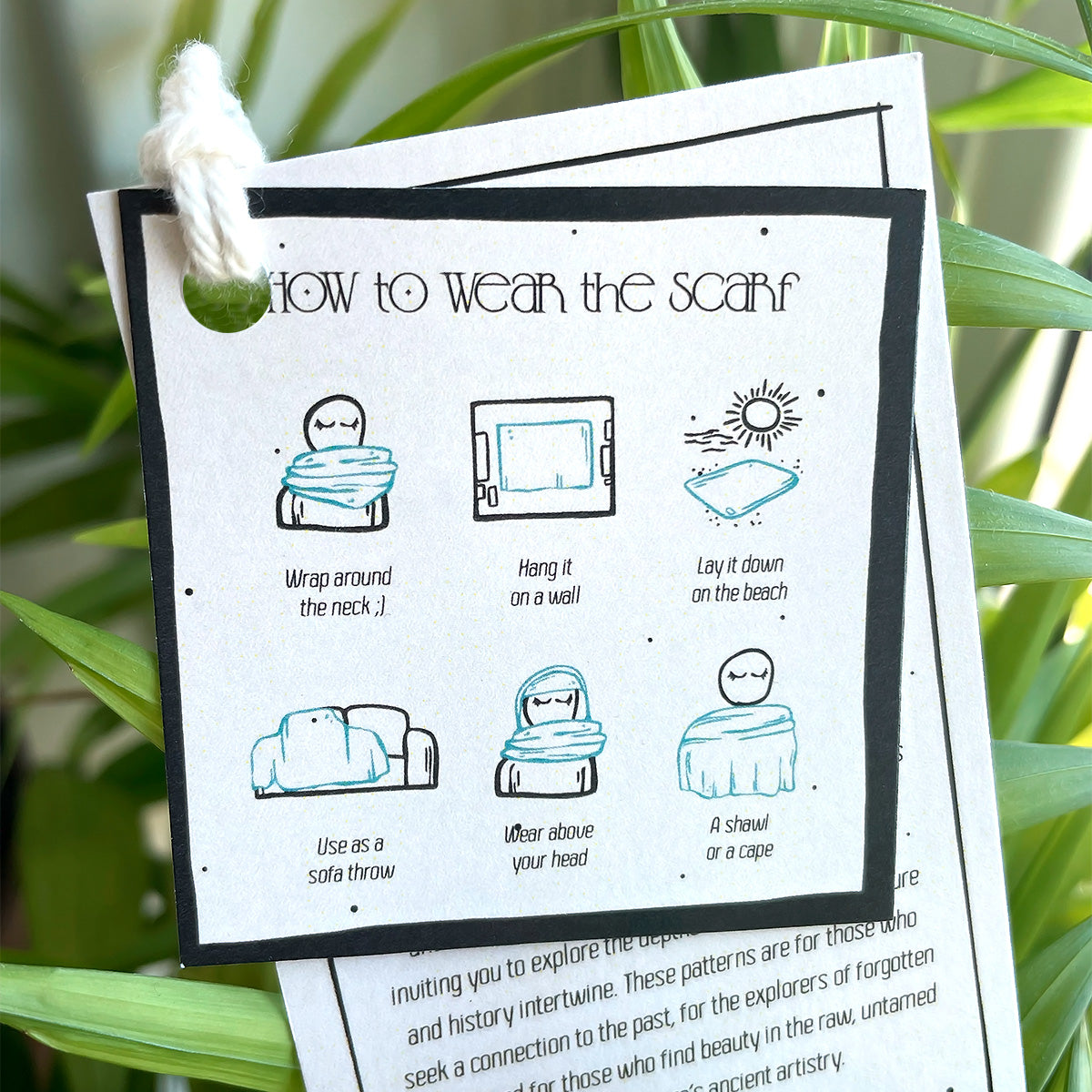 Instructions on how to wear a scarf, with plant background, printed on a hangtag