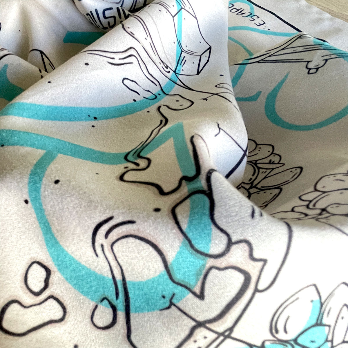 Close up of bandana details, satin material fabric, planet Earth drawing, crystals and small trees, continents, glass jars. Botanical illustrated bandana in cream colour.