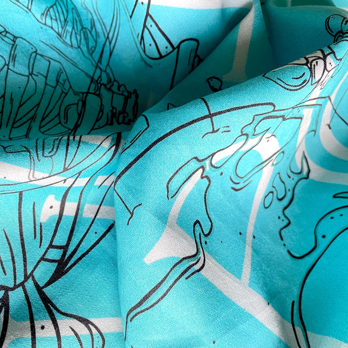 Close up of bandana details, satin material fabric, planet Earth drawing, crystals and small trees, continents, glass jars. Botanical illustrated bandana in teal colour.