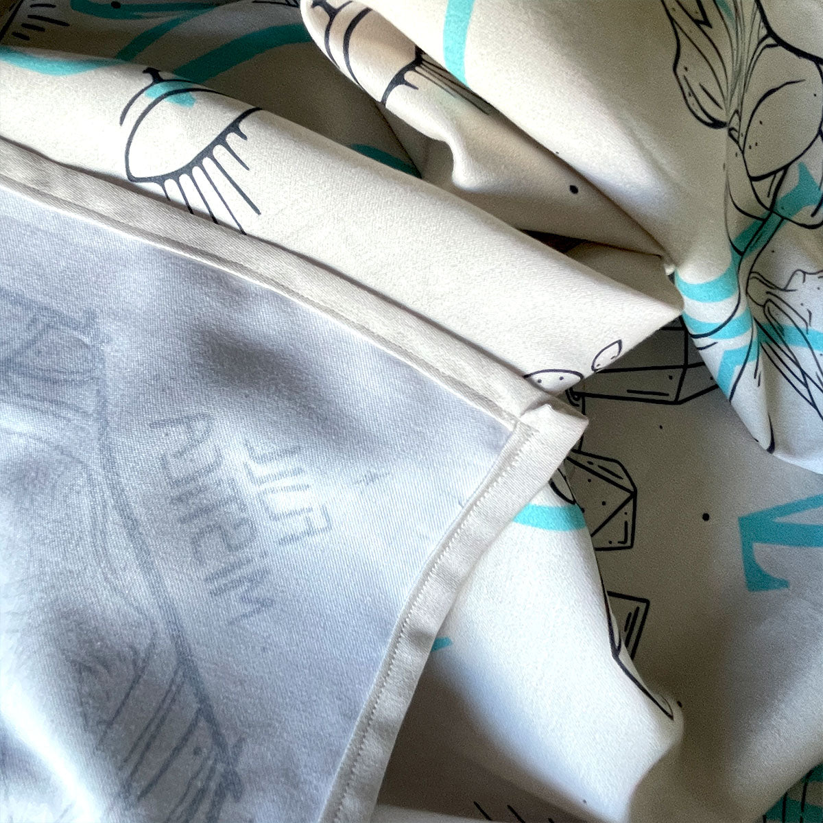 Printed cream bandana featuring a unique design with earth, crystals, plants, and bones. Fans of nature, bohemian fashion, or occult enthusiasts. Folded, sewed hems.