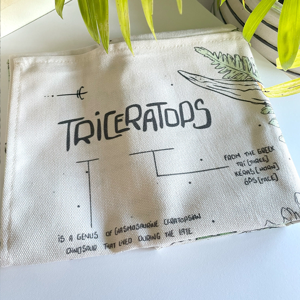 manchester and york museums gift shop triceratop dinosaur tea towel, folded illustrated fabric, curious facts