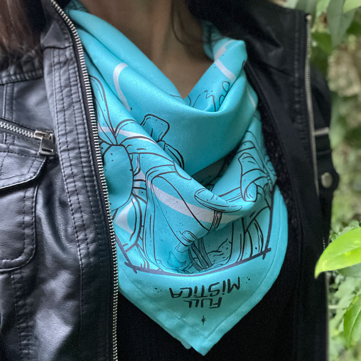 Woman wearing teal colour bandana folded in triangle, outlined illustrations of plants, leaves, glass jar with mushroom inside. The text reads Full Mistica