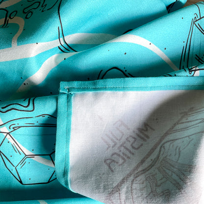 Printed turquoise bandana featuring a unique design with earth, crystals, plants, and bones. Perfect for nature lovers, bohemian fashion, or occult enthusiasts.