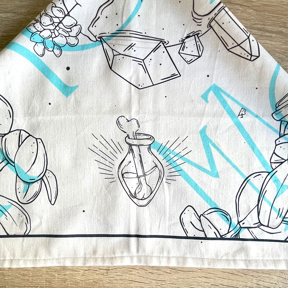 Printed cream bandana featuring a unique design with earth, crystals, plants, and bones. Perfect for nature lovers, bohemian fashion, or occult enthusiasts.