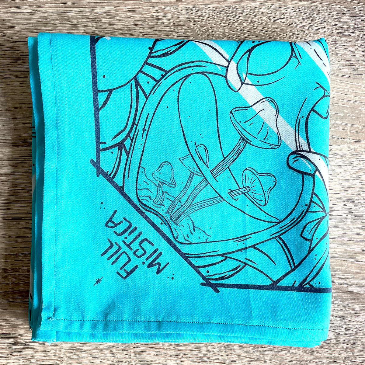 Folded bandana featuring a unique design with Earth, crystals, plants, and bones. Perfect for nature lovers, bohemian fashion, or occult enthusiasts. Turquoise Teal Colour.