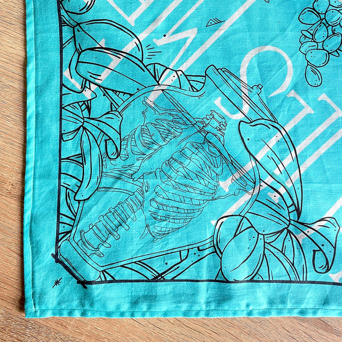 Printed turquoise bandana featuring a unique design with earth, crystals, plants, and bones. Perfect for nature lovers, bohemian fashion, or occult enthusiasts. illustrated skeleton in glass jar