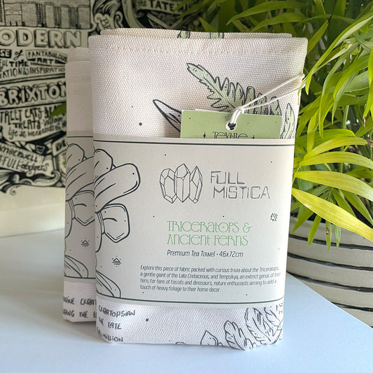 manchester and york museums gift shop triceratops ferns tea towel, folded illustrated fabric 