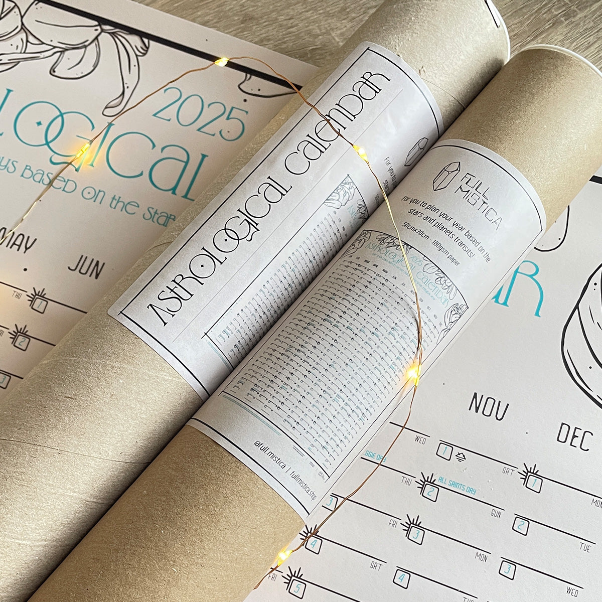 astrological calendar year planner rolled in two cardboard tubes with info label showing design. fairy lights, printed calendar planner under tubes
