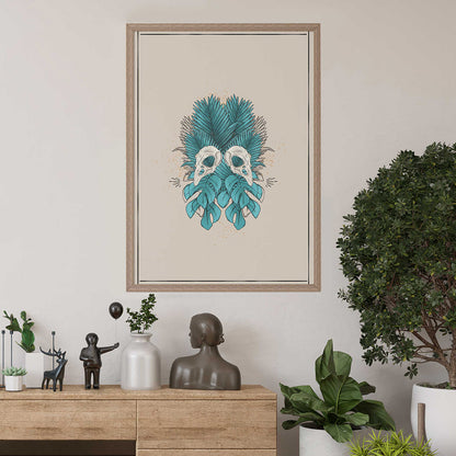 art print hanging, design of two bird skulls mirrored, bold tropical forest leaves in teal, cream background